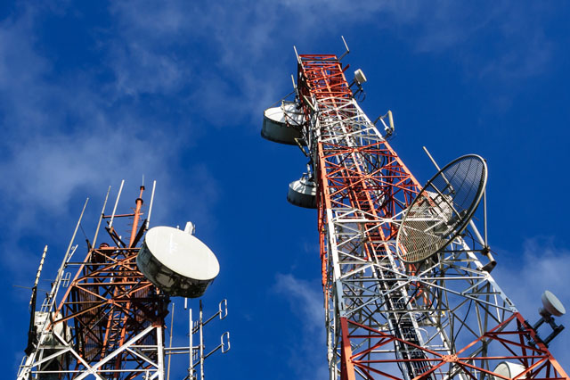Telecom tower installation at sunset